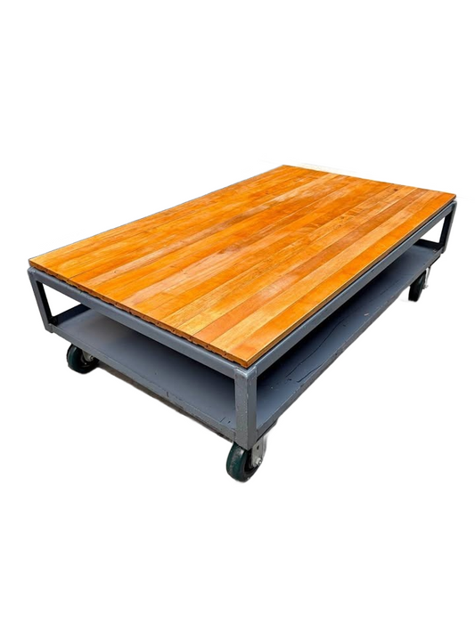 Extra large industrial-style coffee table with solid wood top and gray metal base on wheels