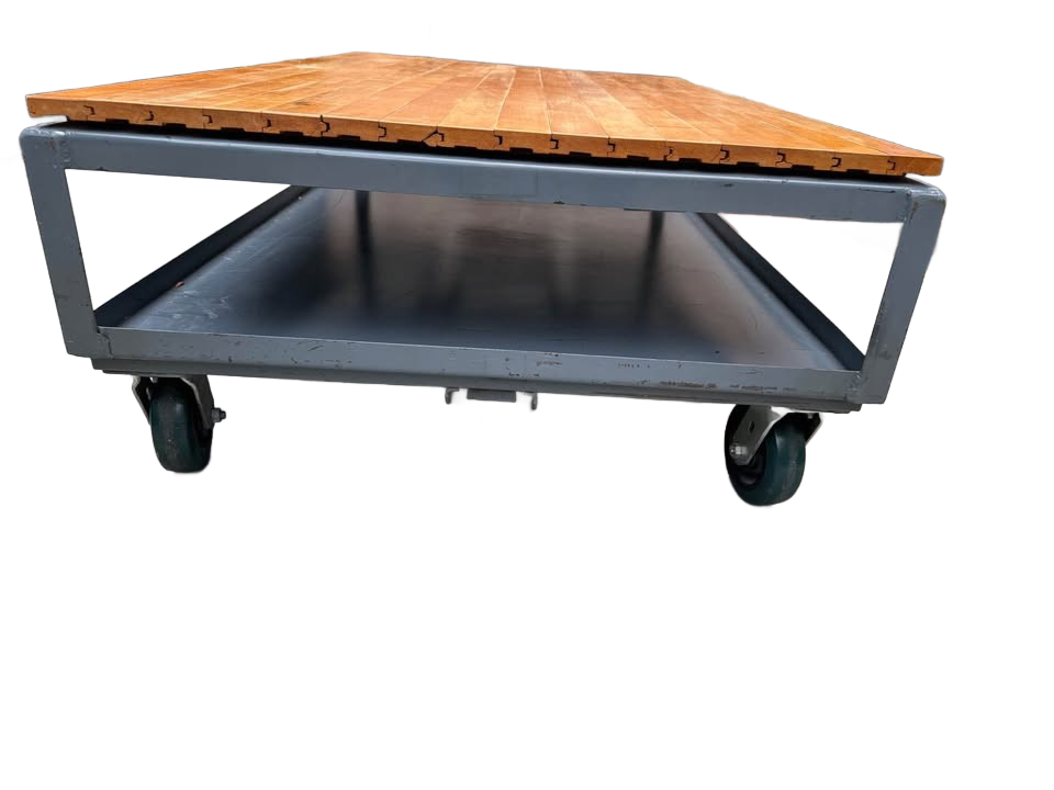 Extra large industrial-style coffee table with solid wood top and gray metal base on wheels