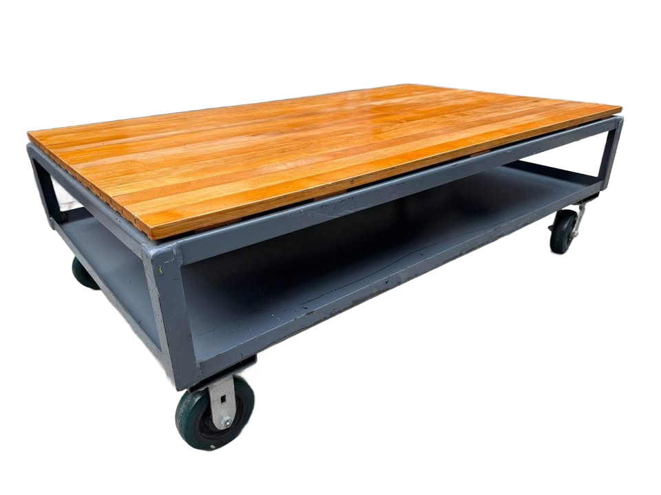 Extra large industrial-style coffee table with solid wood top and gray metal base on wheels