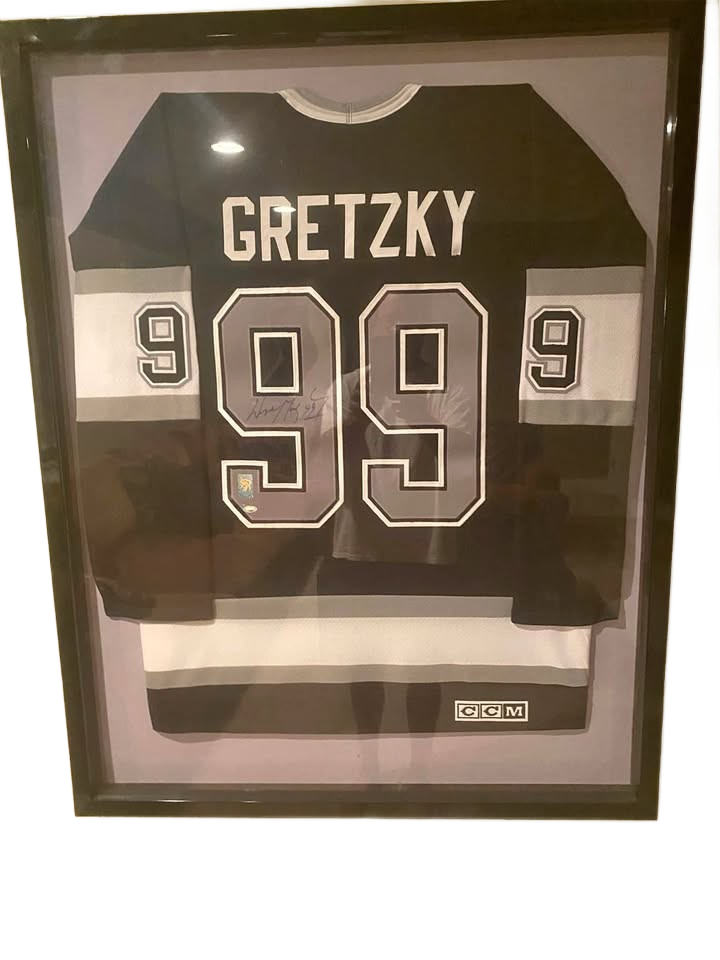 Wayne Gretzky The Great One” autographed LA Kings jersey. COA included. Beautifully frame.